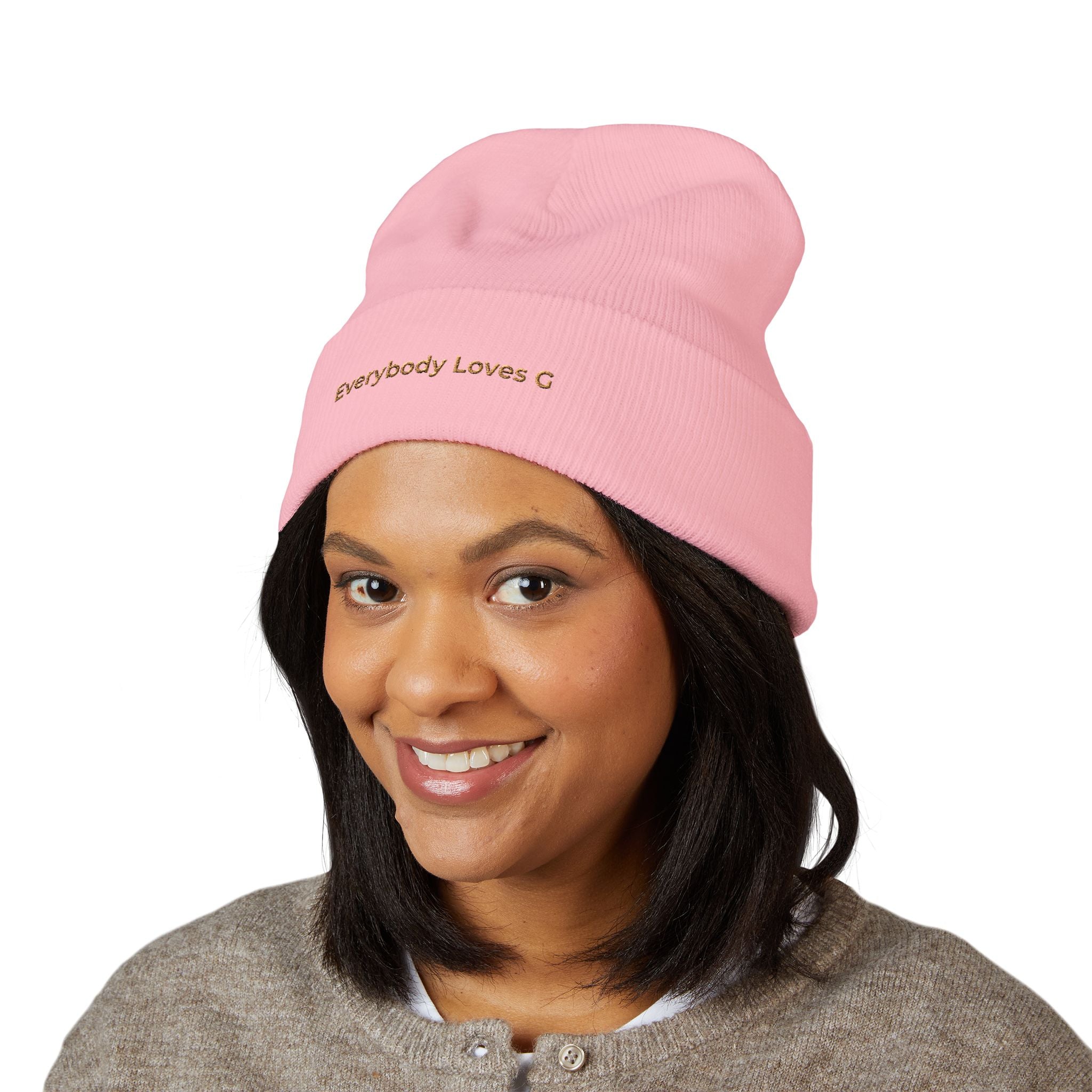 Person wearing a pink everybody loves g beanie on a white background