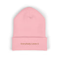 Pink beanie with 'Everybody Loves G' text on a white background